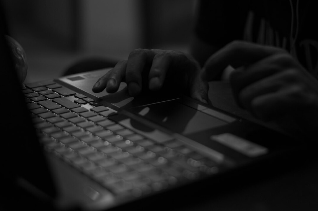 writer typing on laptop at night